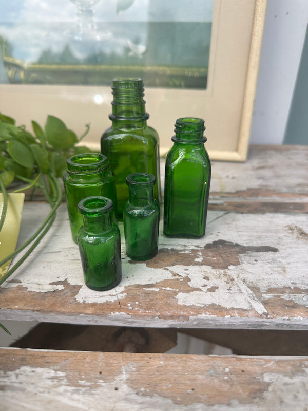 Five mini green bottles