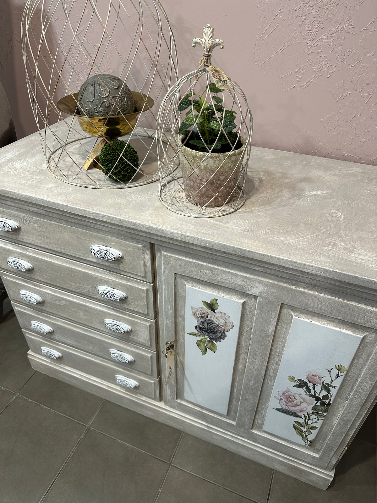 Using the Chateau method layering paint and wax has created this unique Olde Worlde look on this solid sideboard. Shades of grey, white and floral transfers complete the look, Dimensions approx 900mm height x 1200mm length.